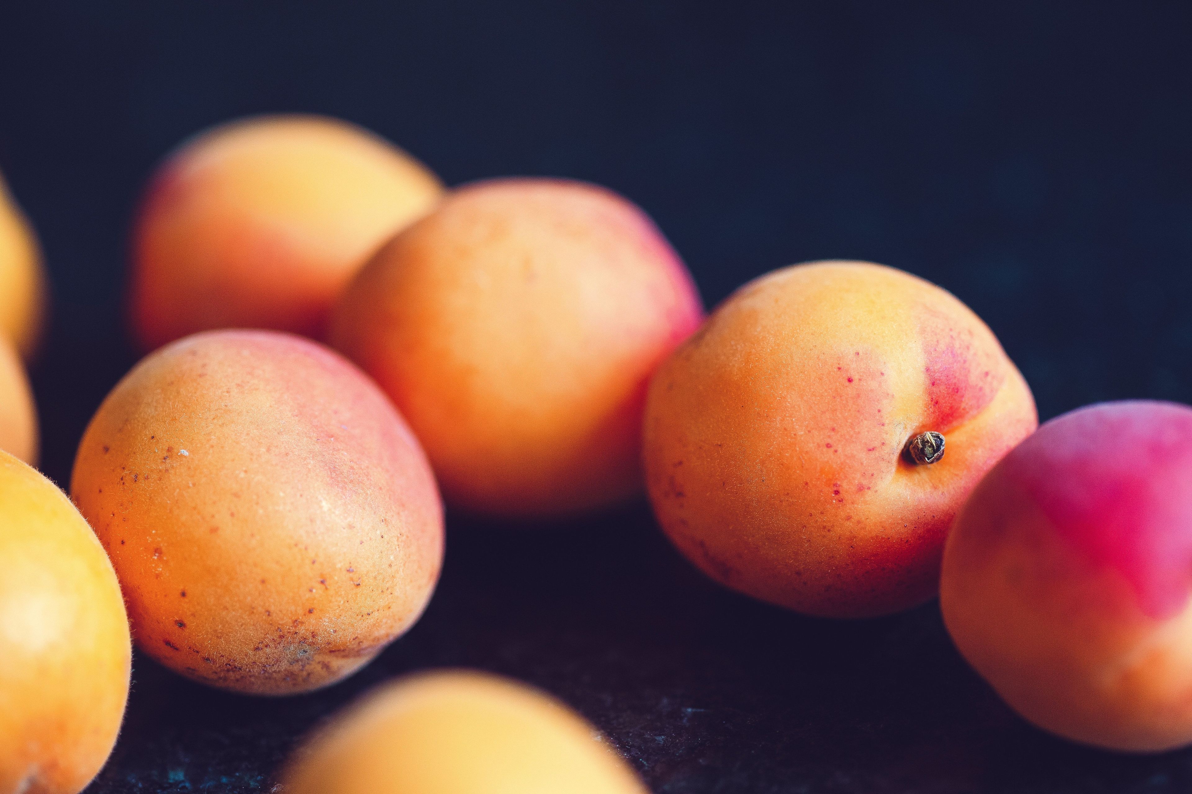 Peaches against dark backgrounds