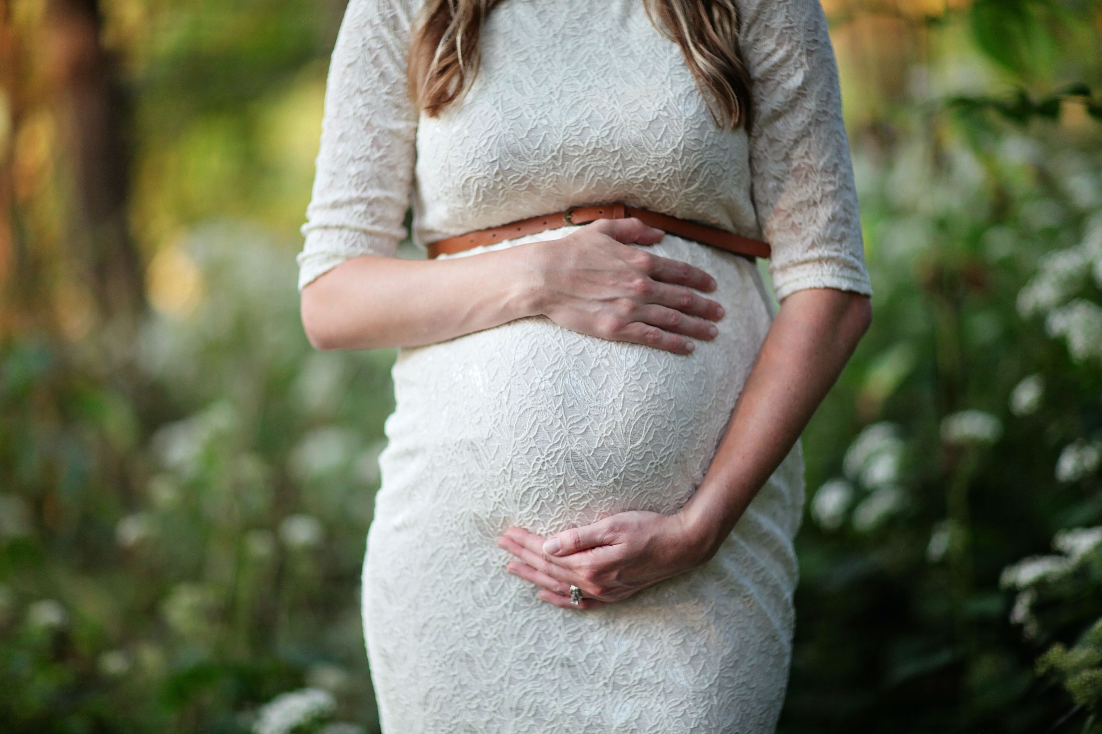 Woman holding her pregnant belly 